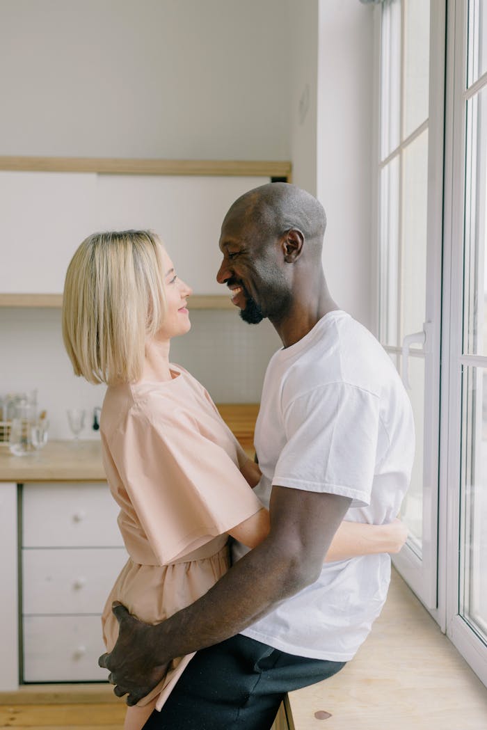 A couple enjoying a cozy moment with coffee outdoors in a scenic mountain setting.
